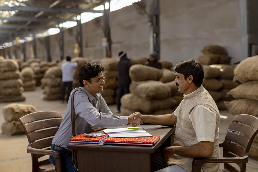 A farmer and a buyer agreeing terms at a mandi